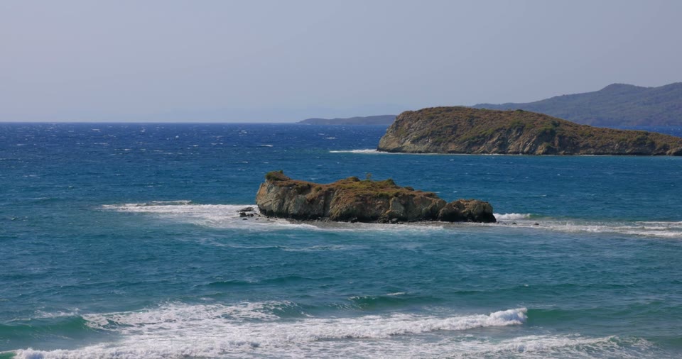 Waves breaking around a rocky coastal island